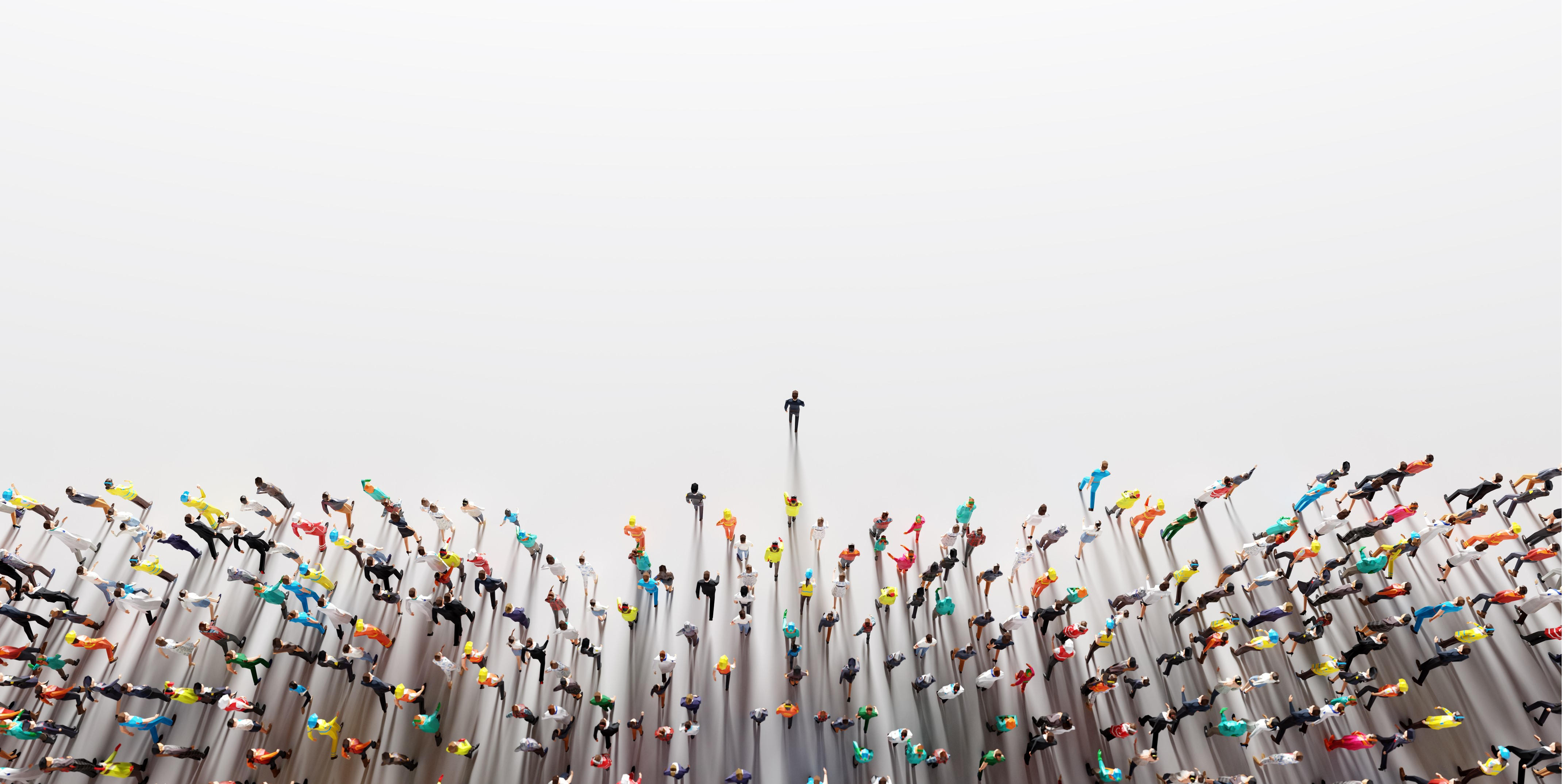 Businessman leading a large group of people from a perspective of looking down from high above them